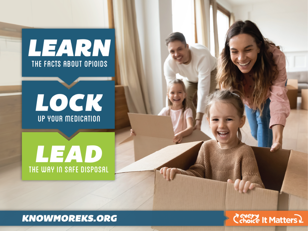 two children sitting in cardboard boxes while their parents push them across the floor in a race